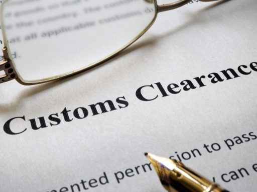 Page of paper with words Customs Clearance and glasses.